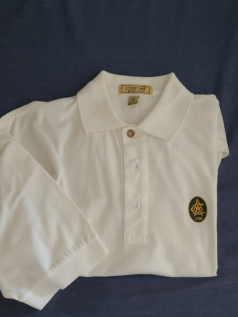 CrossCreek White Polo with Green & Gold Crest